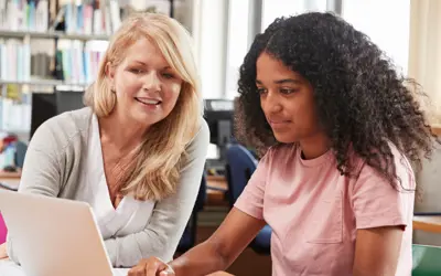 Teen with an adult on the computer